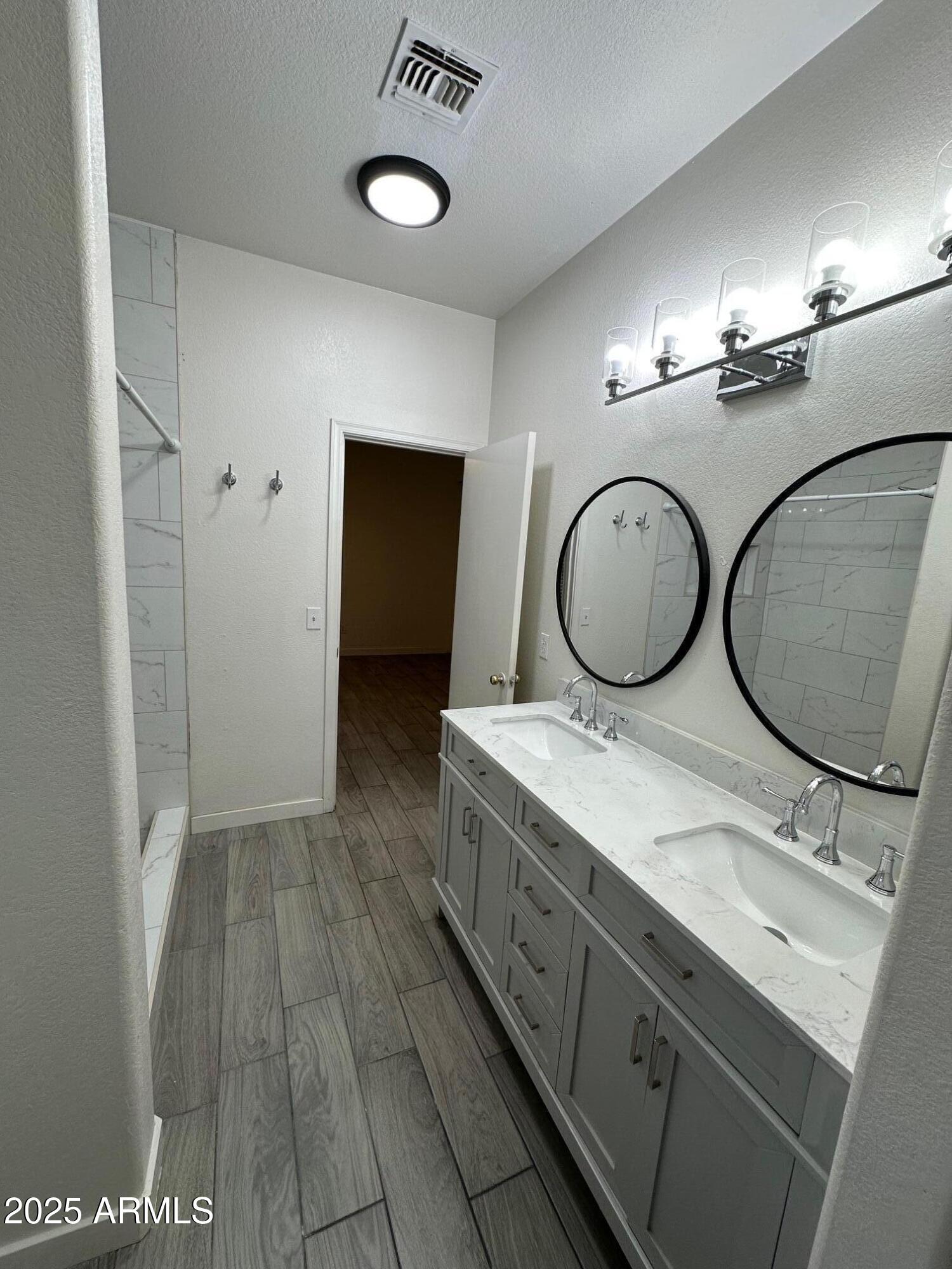 2767 South Sailors Way Gilbert, AZ 85295 - Photo 3 of 15 a bathroom with a double vanity sink and a mirror