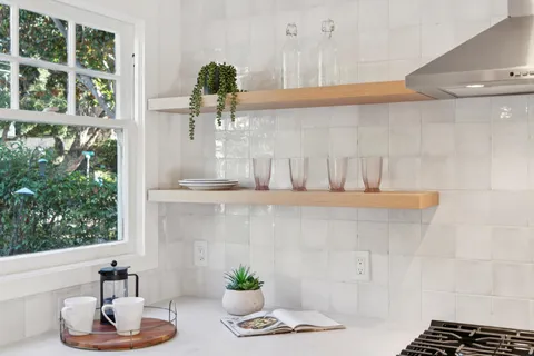 a bathroom with a potted plant and a window