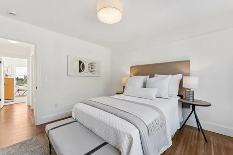 a bedroom with bed and a night stand