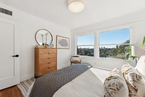 a bedroom with a bed and a large window