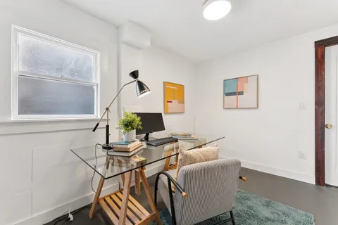 a work room with furniture and a window