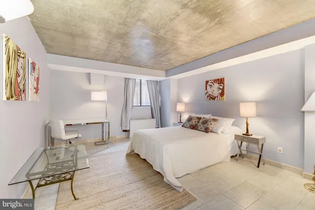 a bedroom with a bed and a table