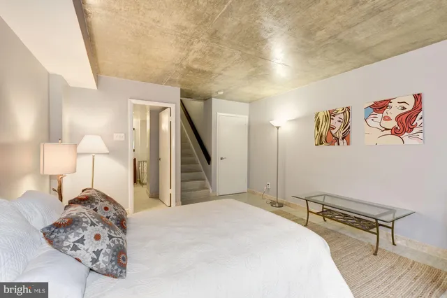 a bed room with a bed and a lamp