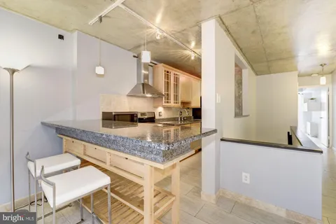 a kitchen with stainless steel appliances granite countertop a stove and a sink