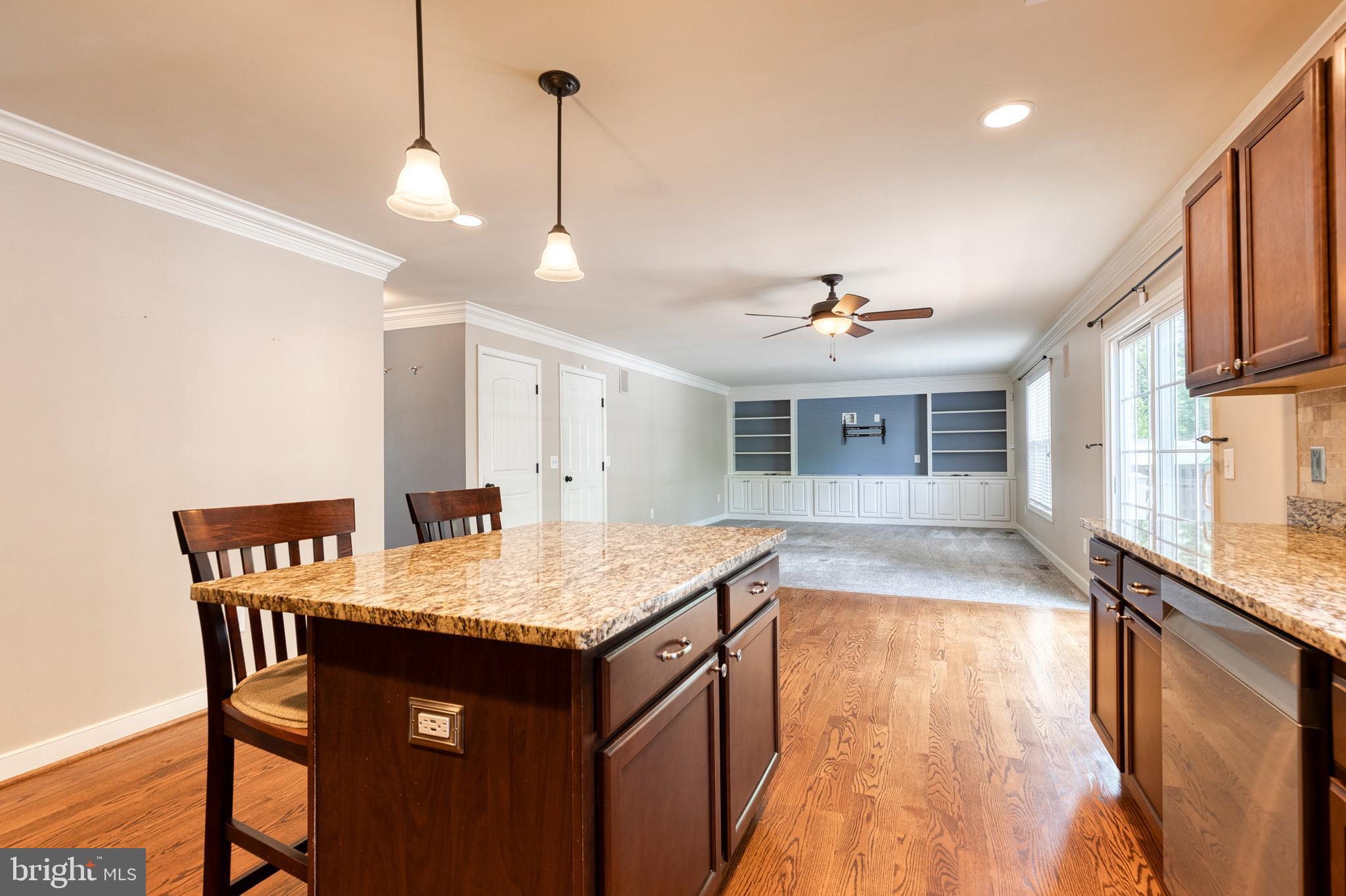 768 Stevenson Road Severn, MD 21144 - Photo 12 of 41 a kitchen with a counter space dining table and chairs