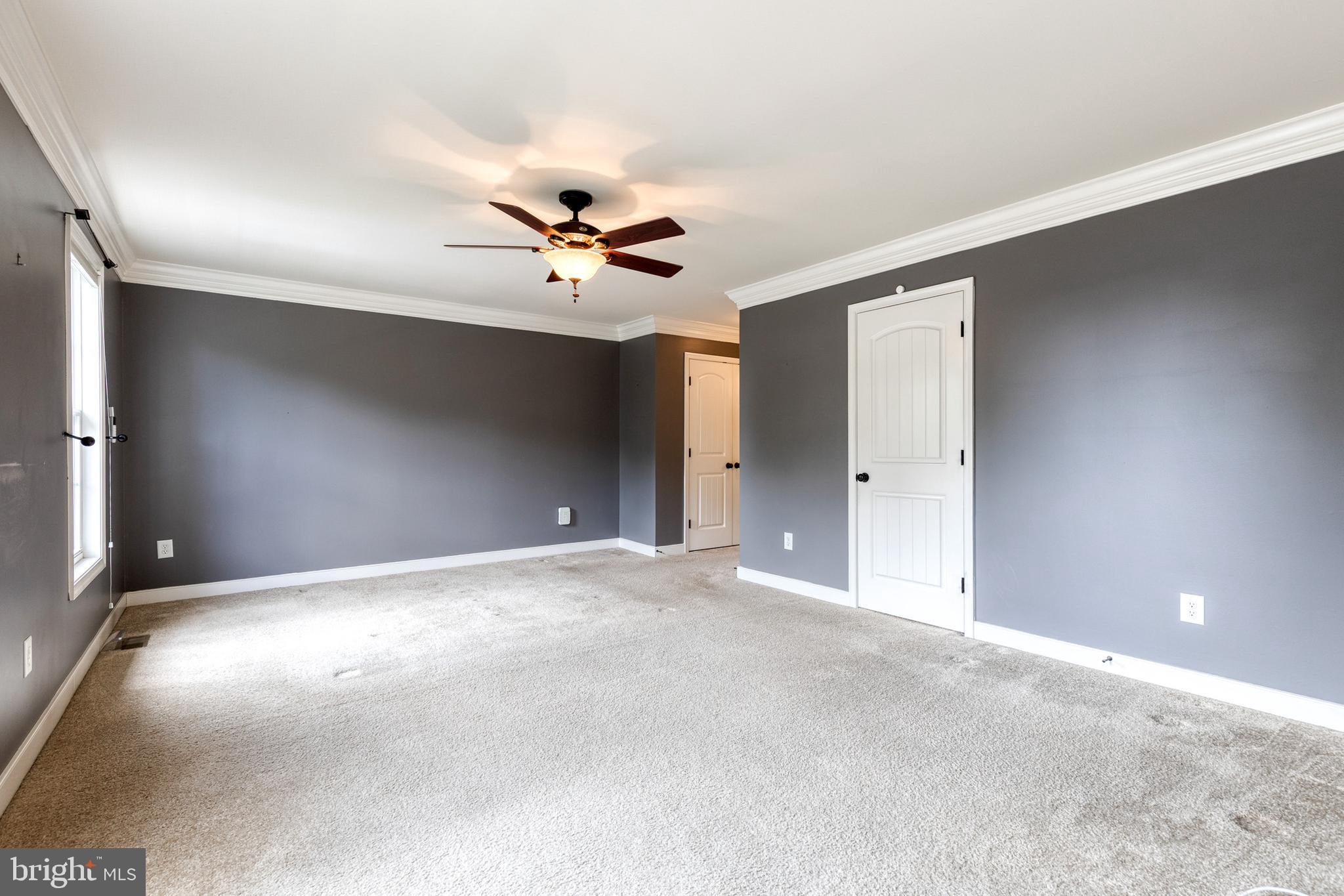 768 Stevenson Road Severn, MD 21144 - Photo 21 of 41 a view of an empty room with a chandelier fan