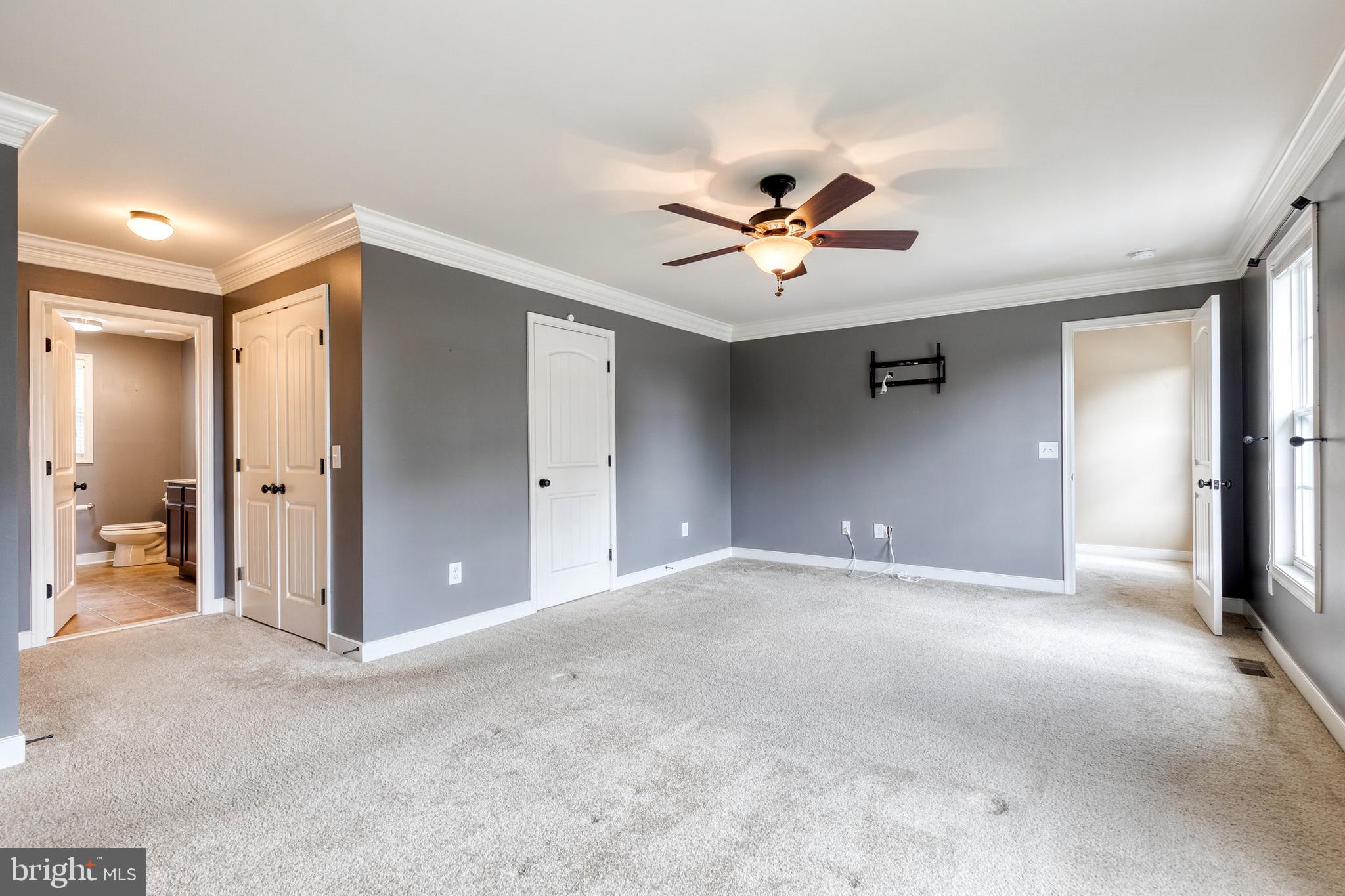 768 Stevenson Road Severn, MD 21144 - Photo 24 of 41 a view of a big room with a ceiling fan and a bathroom