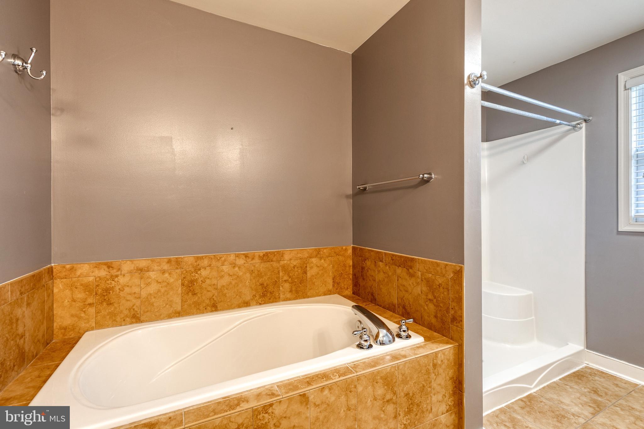 768 Stevenson Road Severn, MD 21144 - Photo 26 of 41 a bathroom with a tub and shower