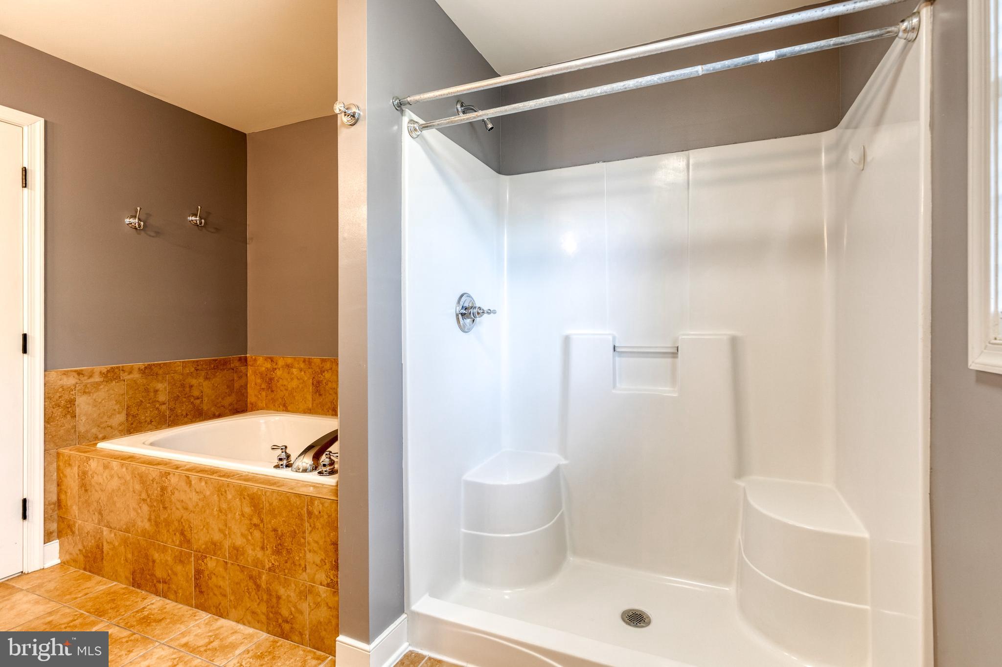 768 Stevenson Road Severn, MD 21144 - Photo 27 of 41 a bathroom with a tub and shower