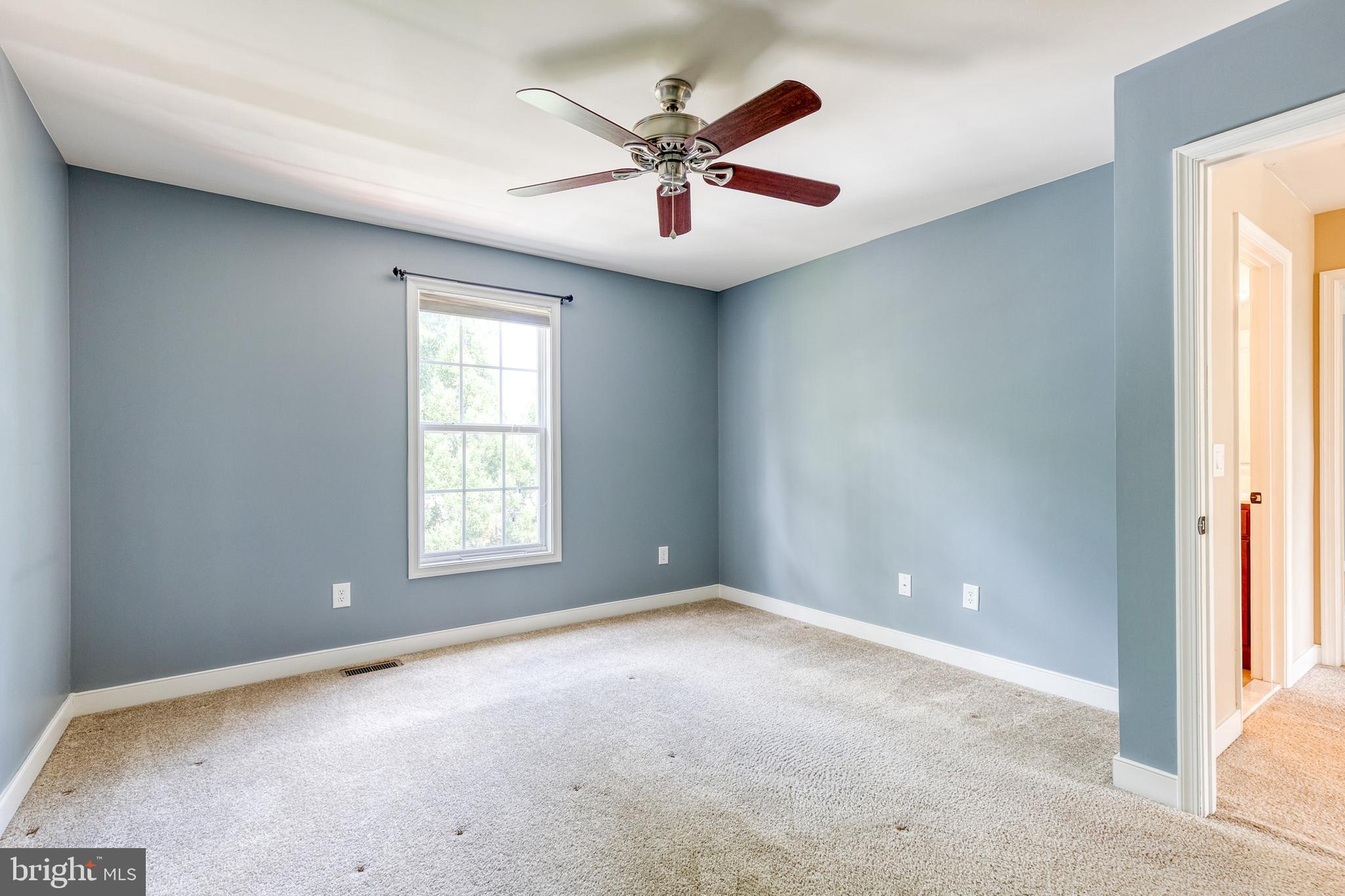 768 Stevenson Road Severn, MD 21144 - Photo 28 of 41 an empty room with ceiling fan and windows