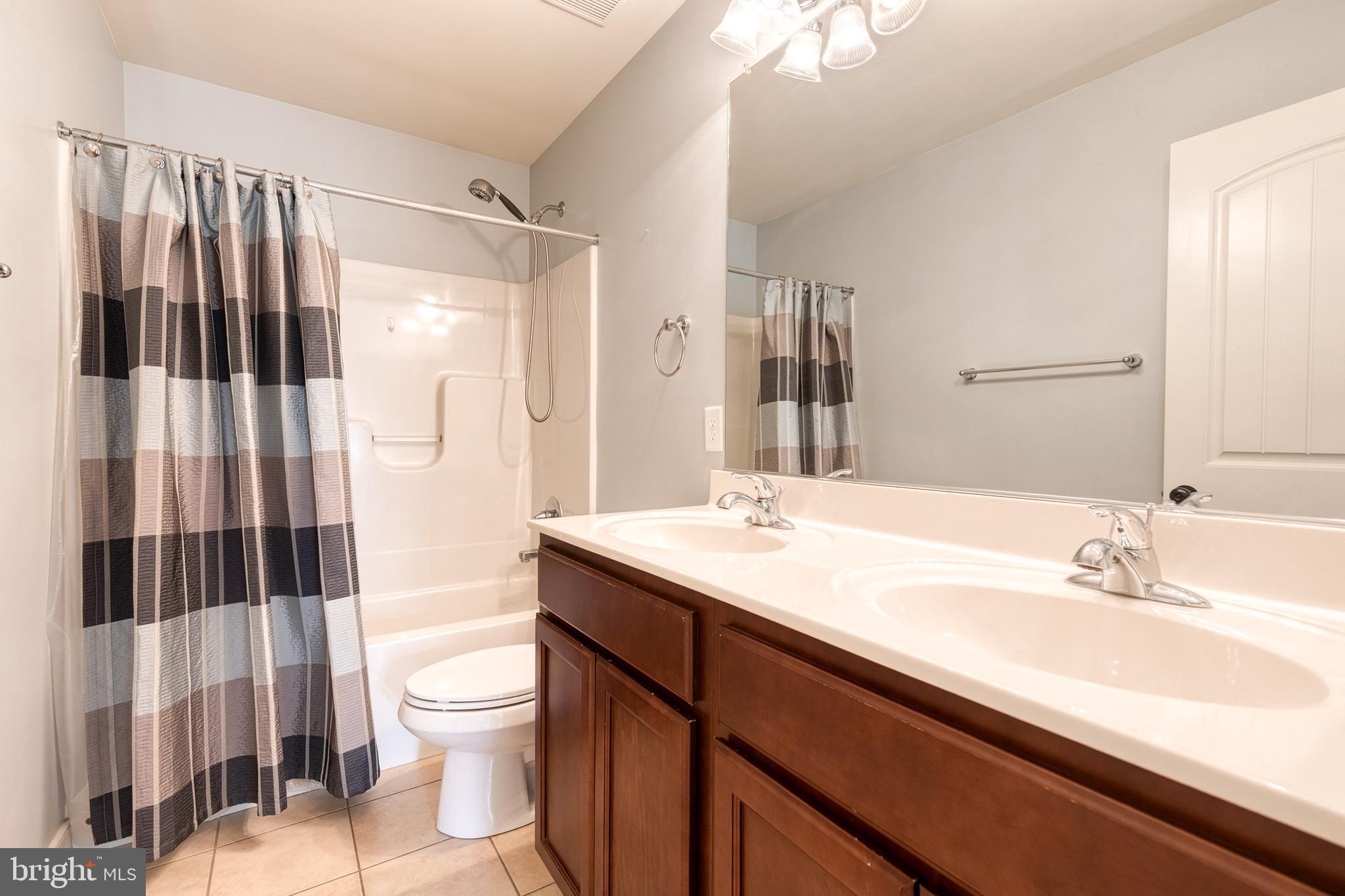 768 Stevenson Road Severn, MD 21144 - Photo 31 of 41 a bathroom with a sink toilet double vanity and shower