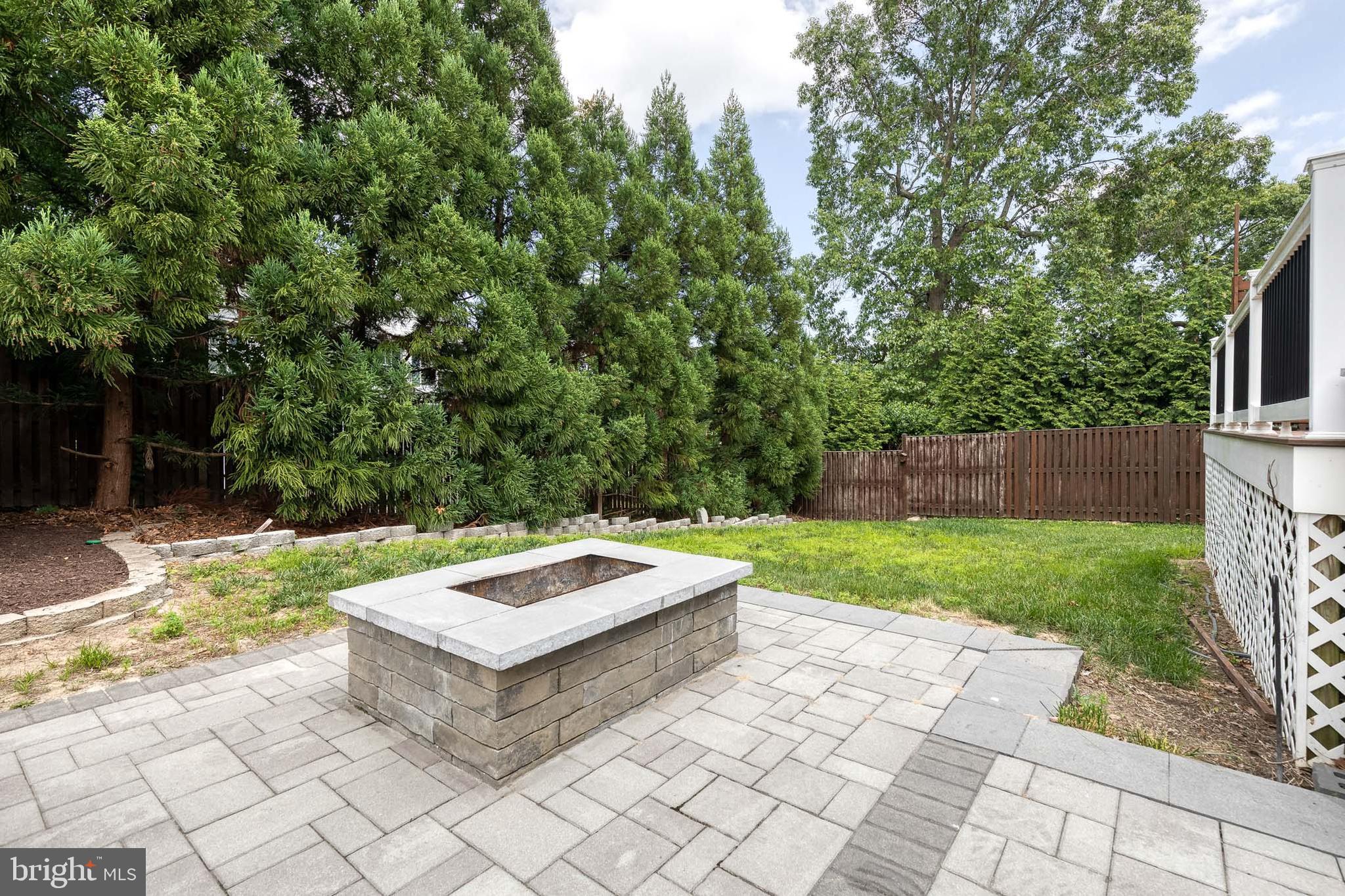 768 Stevenson Road Severn, MD 21144 - Photo 39 of 41 a wooden bench sitting in the grass near a tree