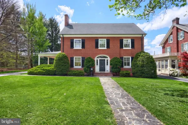 a front view of a house with a yard and porch