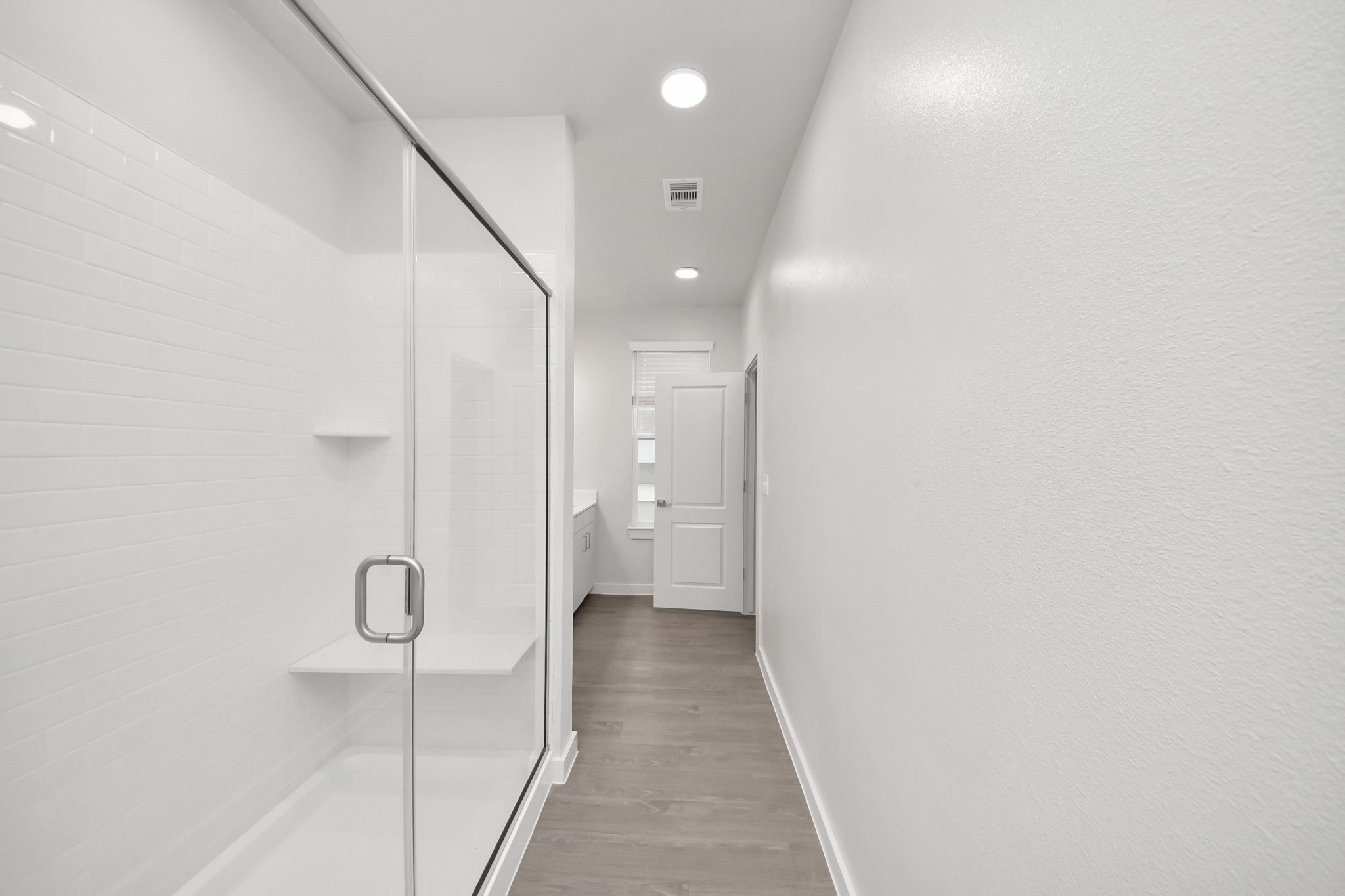 7306 Corey Rushing Lane Richmond, TX 77407 - Photo 27 of 49 Spacious Owner’s retreat with wood-like floors, walk-in closet and spa-like bath w/dual sinks.