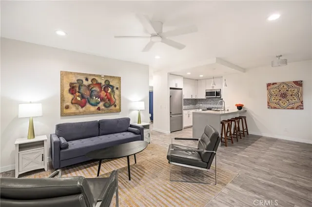 a living room with furniture and a kitchen view