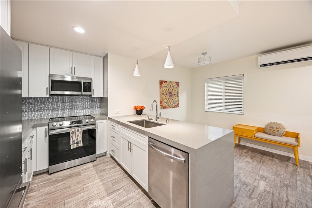 435 East Chuckwalla Road Palm Springs, CA 92262 - Photo 20 of 24 a kitchen with stainless steel appliances granite countertop a stove a sink and a microwave