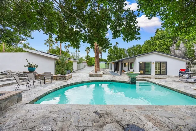 swimming pool view with a seating space