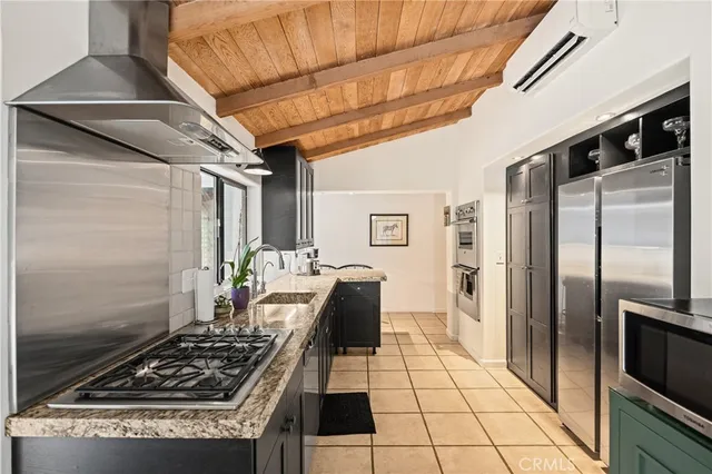 a kitchen with stainless steel appliances granite countertop a stove a refrigerator and a refrigerator