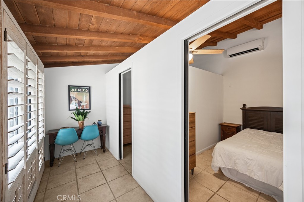 435 East Chuckwalla Road Palm Springs, CA 92262 - Photo 8 of 24 a bedroom with a bed and a chandelier