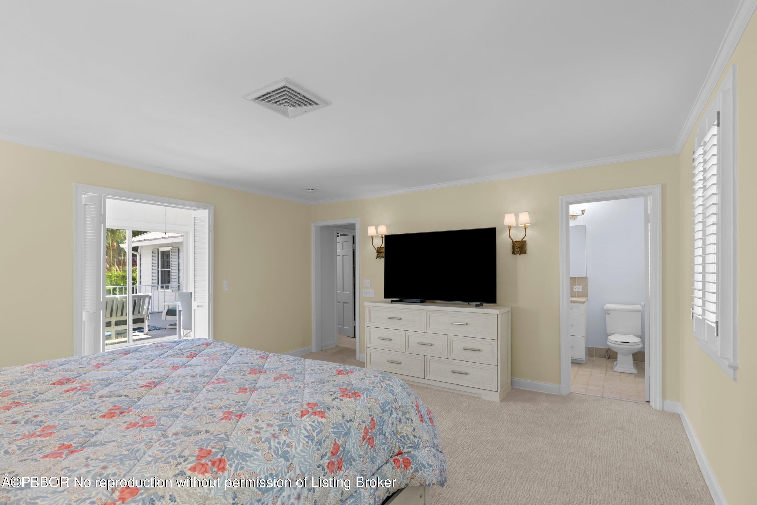323 Arabian Road Palm Beach, FL 33480 - Photo 11 of 21 a bedroom with a bed and a flat screen tv