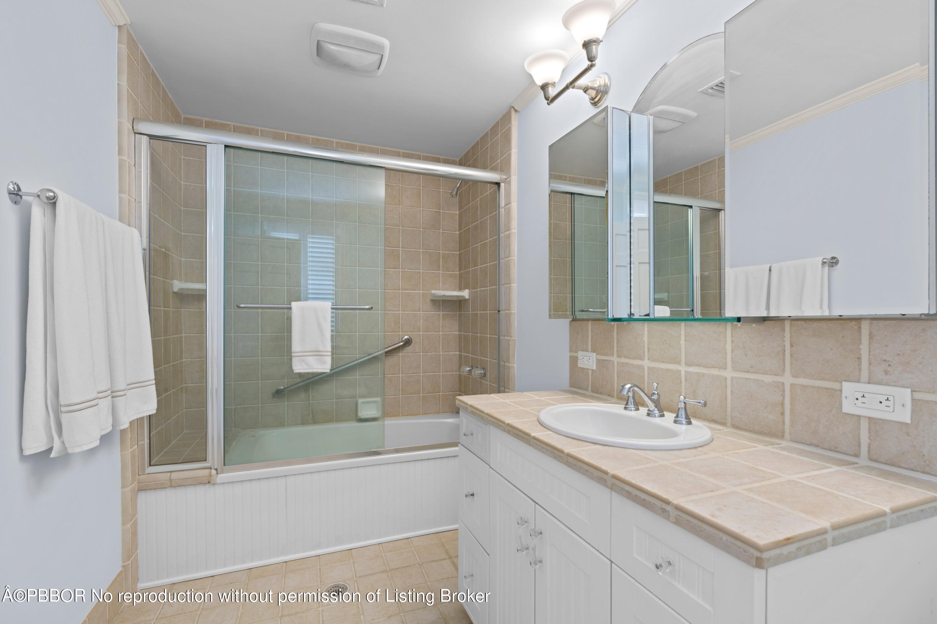 323 Arabian Road Palm Beach, FL 33480 - Photo 12 of 21 a bathroom with a sink shower and a mirror