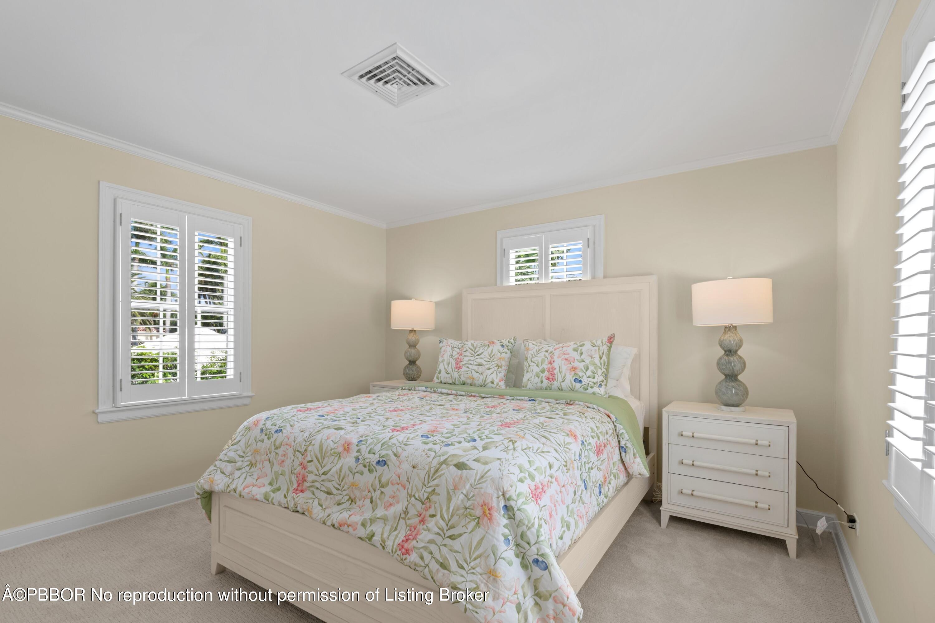 323 Arabian Road Palm Beach, FL 33480 - Photo 13 of 21 a bedroom with a bed a lamp and a window
