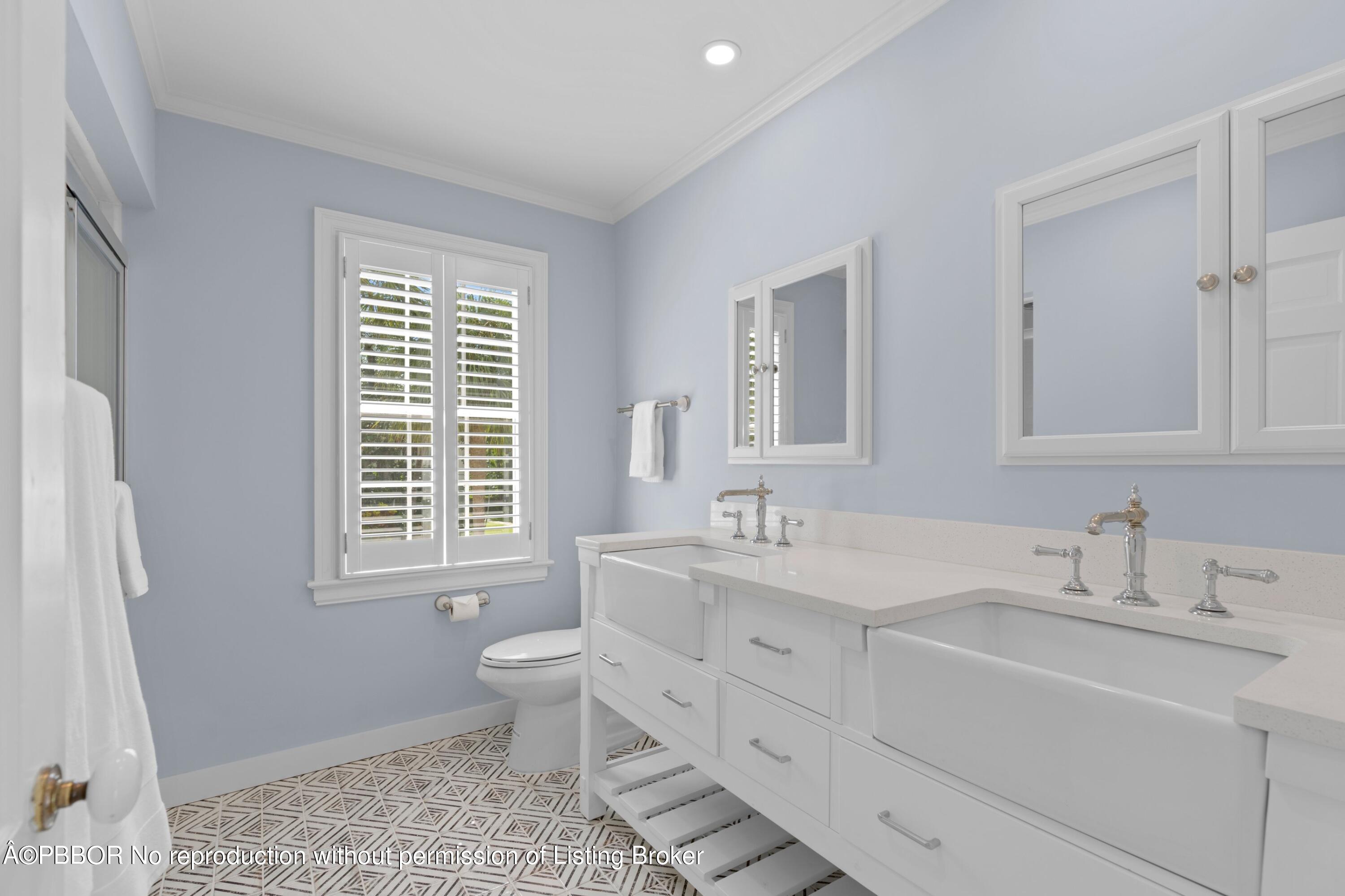 323 Arabian Road Palm Beach, FL 33480 - Photo 14 of 21 a bathroom with double vanity sink a mirror and a toilet