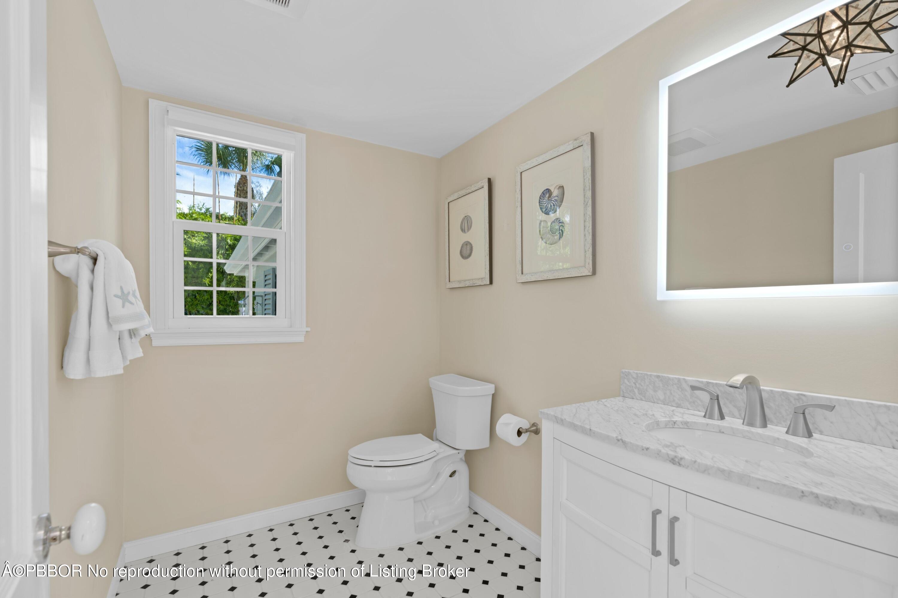 323 Arabian Road Palm Beach, FL 33480 - Photo 16 of 21 a bathroom with a granite countertop toilet sink and mirror