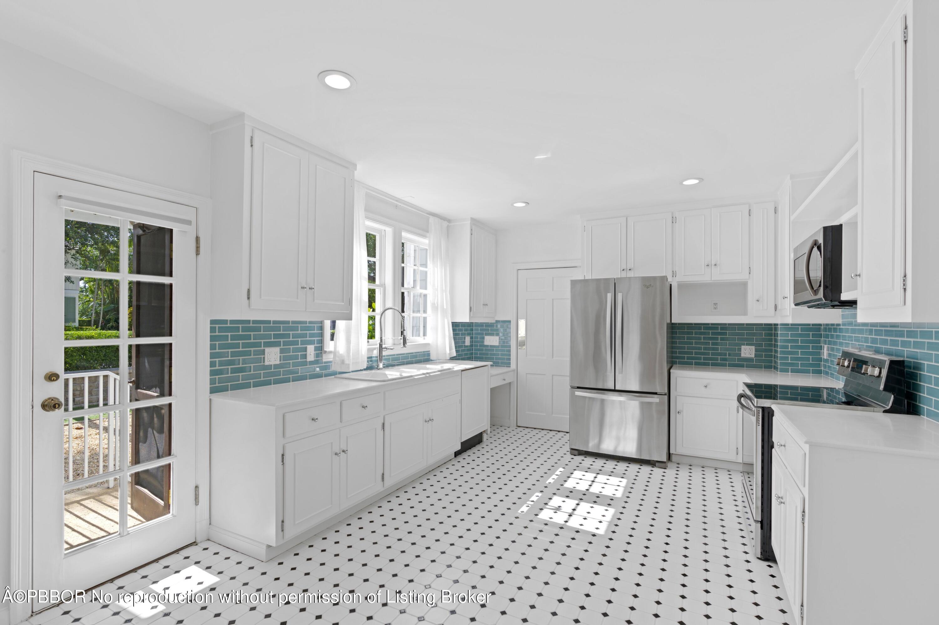 323 Arabian Road Palm Beach, FL 33480 - Photo 7 of 21 a kitchen with a refrigerator a stove top oven and a window