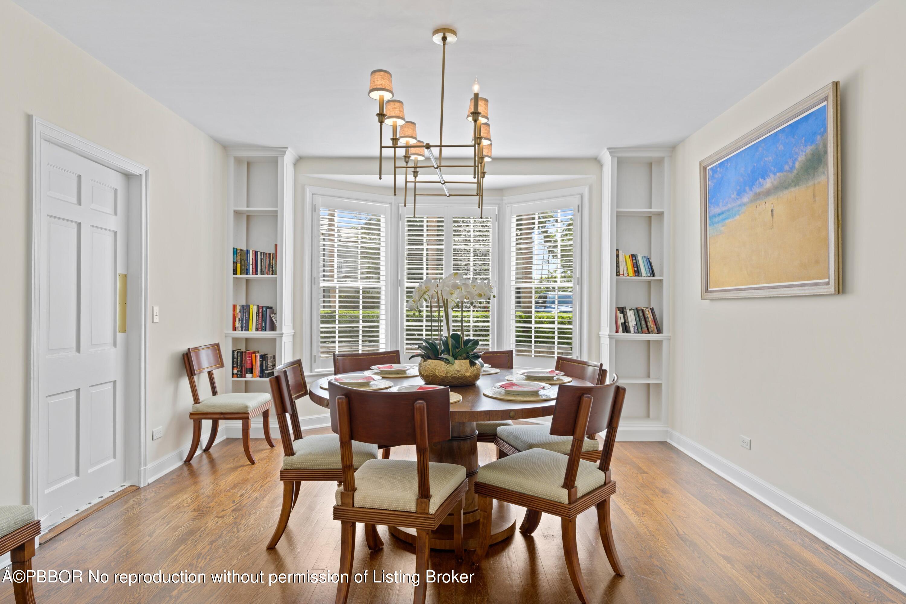 323 Arabian Road Palm Beach, FL 33480 - Photo 9 of 21 a dining room with furniture a chandelier and wooden floor