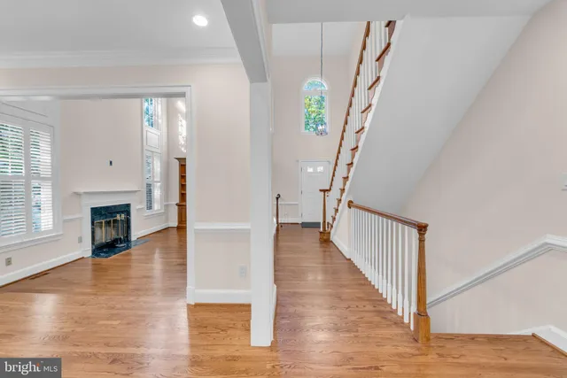 a kitchen that has a sink a stove and wooden floor