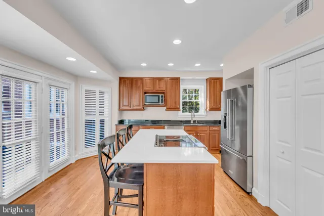 a kitchen with stainless steel appliances granite countertop a refrigerator sink and stove