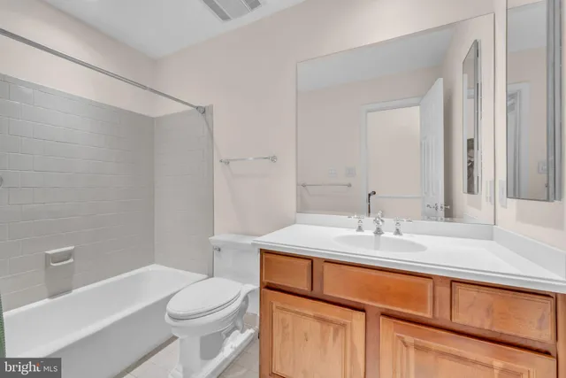 a dining room with furniture a chandelier and wooden floor