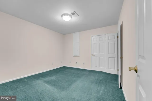 a bathroom with a granite countertop shower a sink and a window