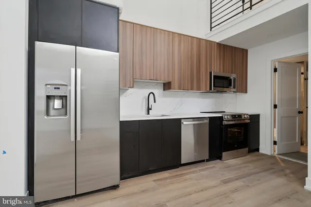 a kitchen with a refrigerator stove and sink