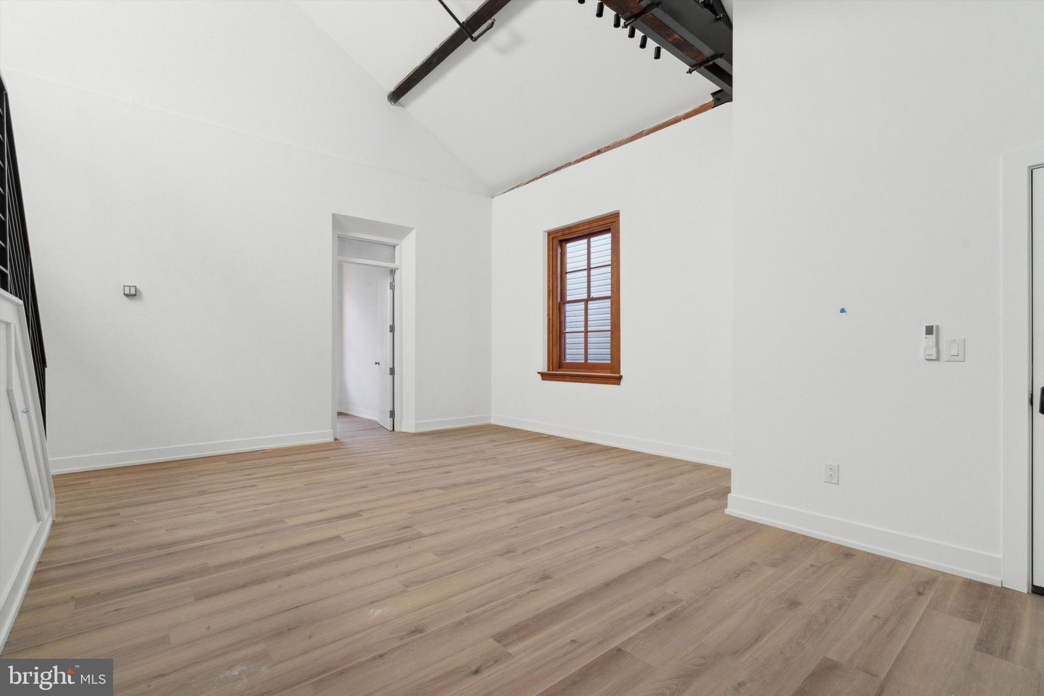 808 North 3rd Street, Unit 26 Philadelphia, PA 19123 - Photo 6 of 7 an empty room with wooden floor and windows
