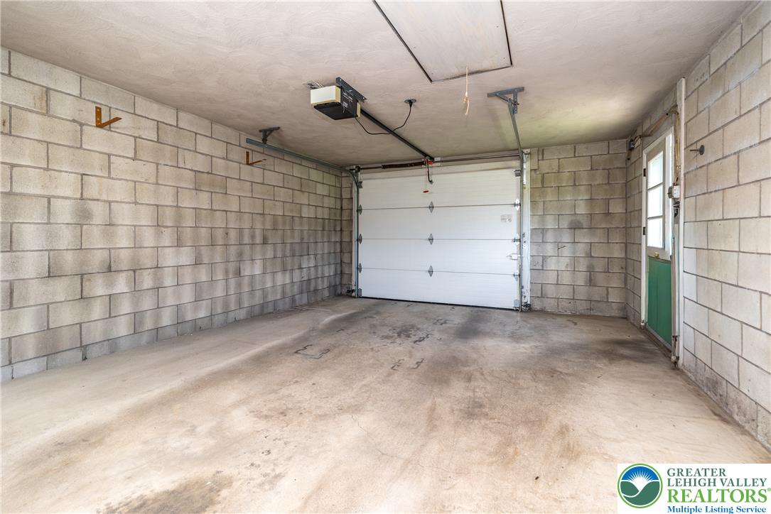 2132 Cypress Road Bethlehem, PA 18018 - Photo 12 of 16 A spacious garage features concrete block walls and an electric garage door additional overhead storage