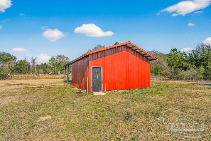 8940 Indian Ford Road Milton, FL 32570 - Photo 7 of 54 a view of an empty room with a yard