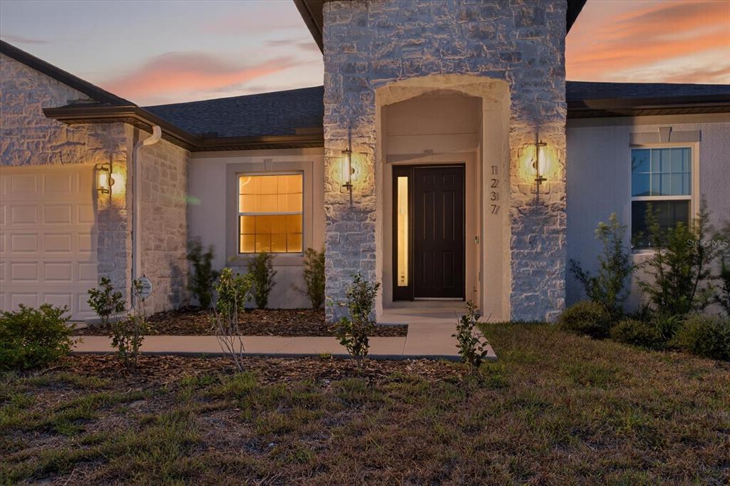 1237 Kelsa Anne Dr Spring Hill Spring Hill, FL 34609 - Photo 3 of 94 a front view of a house with a yard