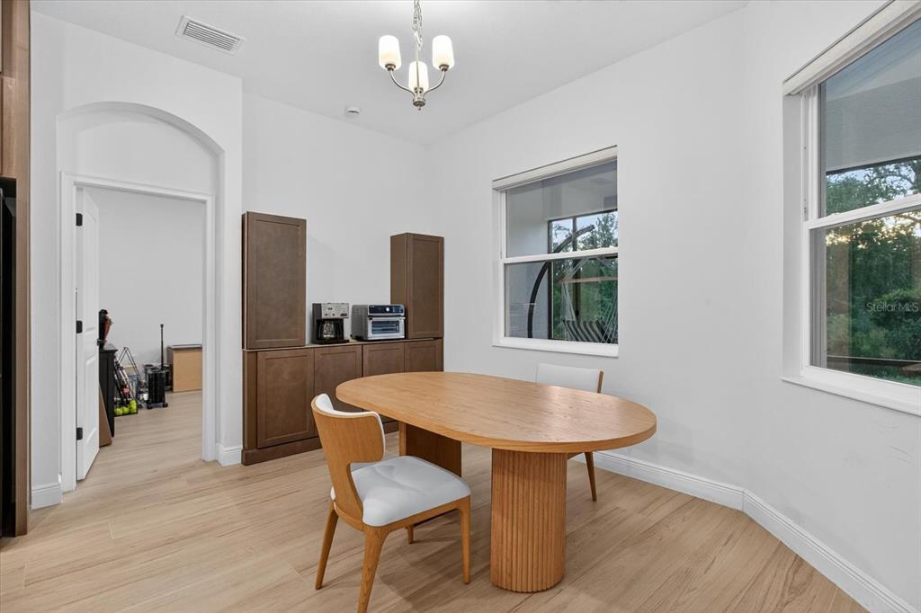 1237 Kelsa Anne Dr Spring Hill Spring Hill, FL 34609 - Photo 35 of 94 a view of a dining room with furniture window and wooden floor