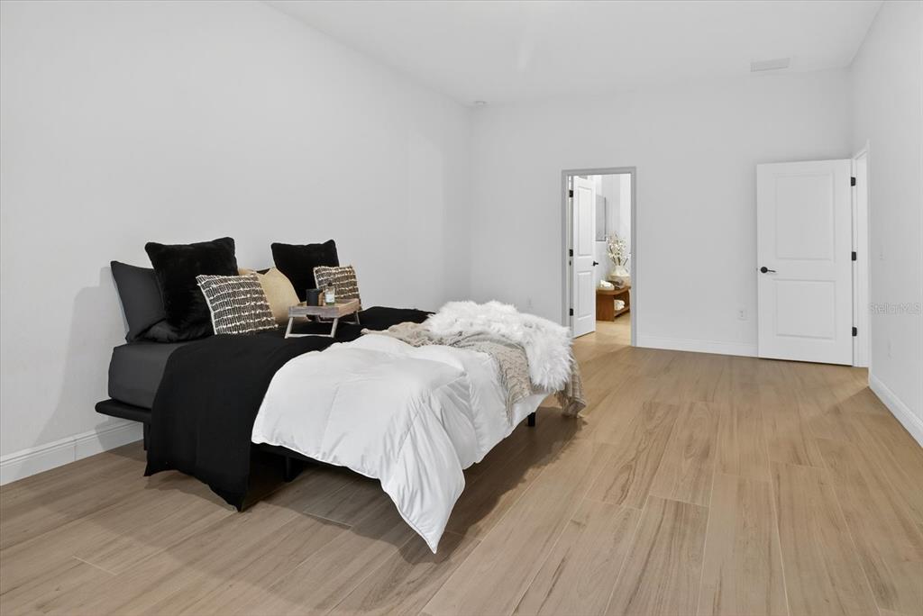 1237 Kelsa Anne Dr Spring Hill Spring Hill, FL 34609 - Photo 39 of 94 a bedroom with bed and a night stand