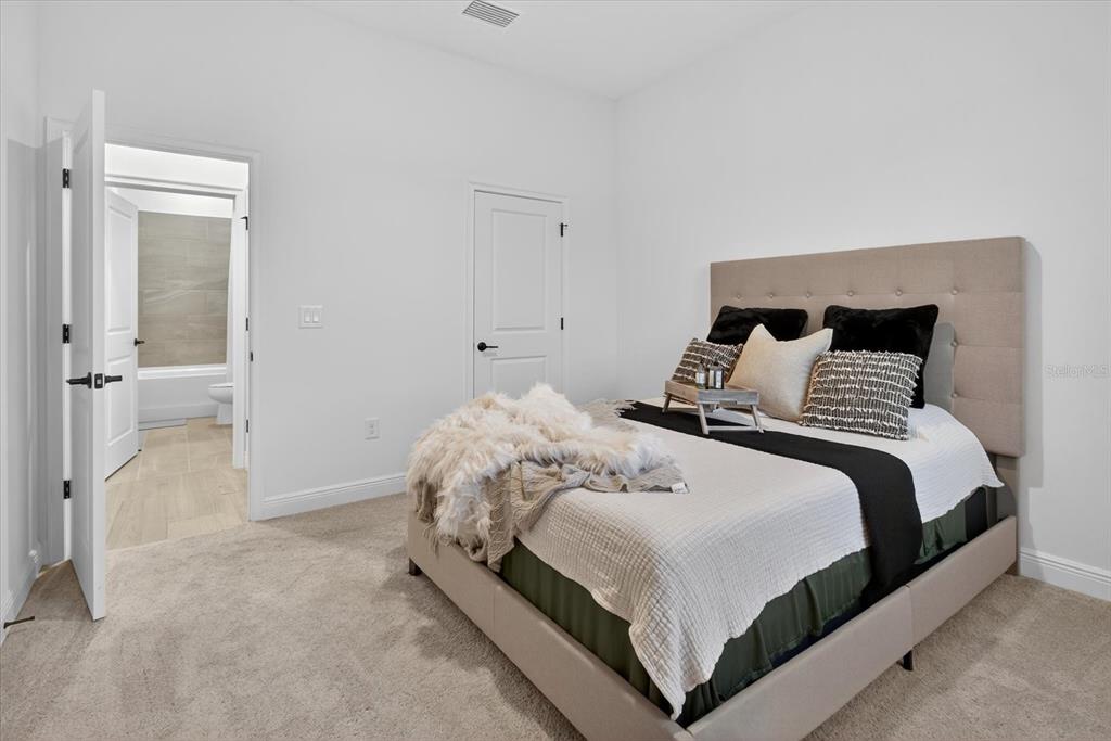 1237 Kelsa Anne Dr Spring Hill Spring Hill, FL 34609 - Photo 50 of 94 a bedroom with a bed and a walk in closet