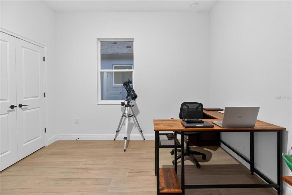 1237 Kelsa Anne Dr Spring Hill Spring Hill, FL 34609 - Photo 57 of 94 a view of a workspace with furniture and wooden floor