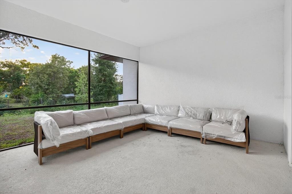 1237 Kelsa Anne Dr Spring Hill Spring Hill, FL 34609 - Photo 66 of 94 a living room with furniture and a large window