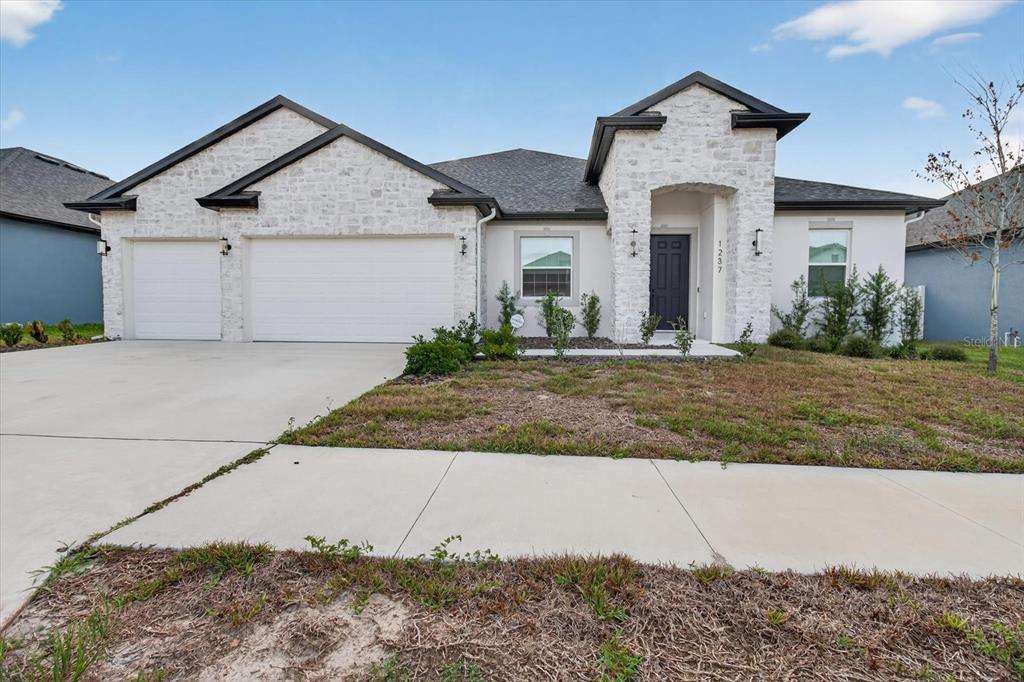 1237 Kelsa Anne Dr Spring Hill Spring Hill, FL 34609 - Photo 73 of 94 a front view of a house with a yard