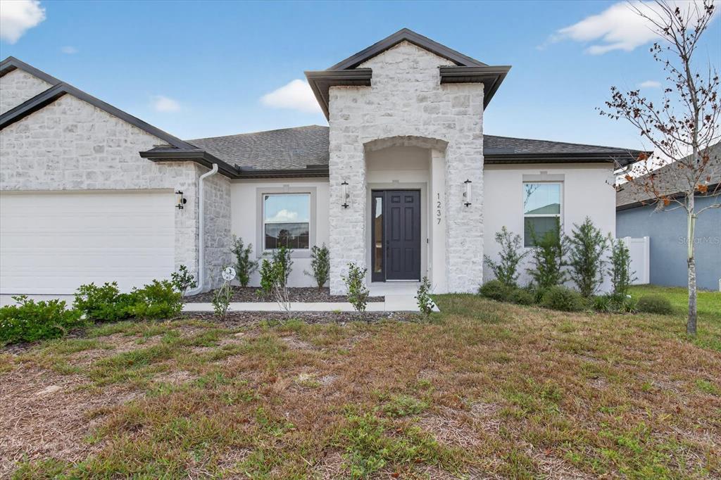 1237 Kelsa Anne Dr Spring Hill Spring Hill, FL 34609 - Photo 74 of 94 a front view of a house with a yard