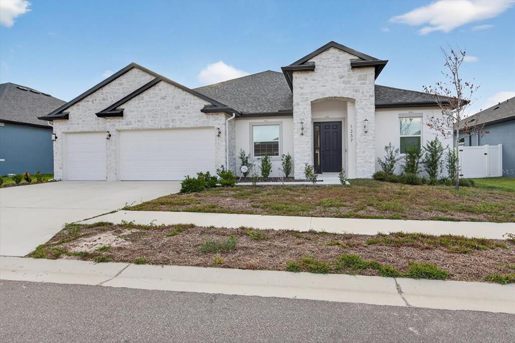 1237 Kelsa Anne Dr Spring Hill Spring Hill, FL 34609 - Photo 82 of 94 a front view of a house with a yard