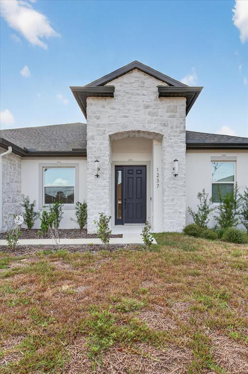 1237 Kelsa Anne Dr Spring Hill Spring Hill, FL 34609 - Photo 83 of 94 a front view of a house with a yard