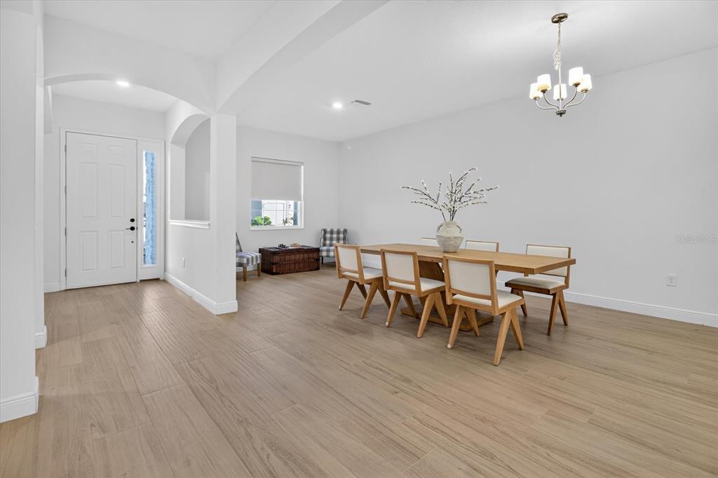 1237 Kelsa Anne Dr Spring Hill Spring Hill, FL 34609 - Photo 9 of 94 a view of a dining room with furniture and wooden floor
