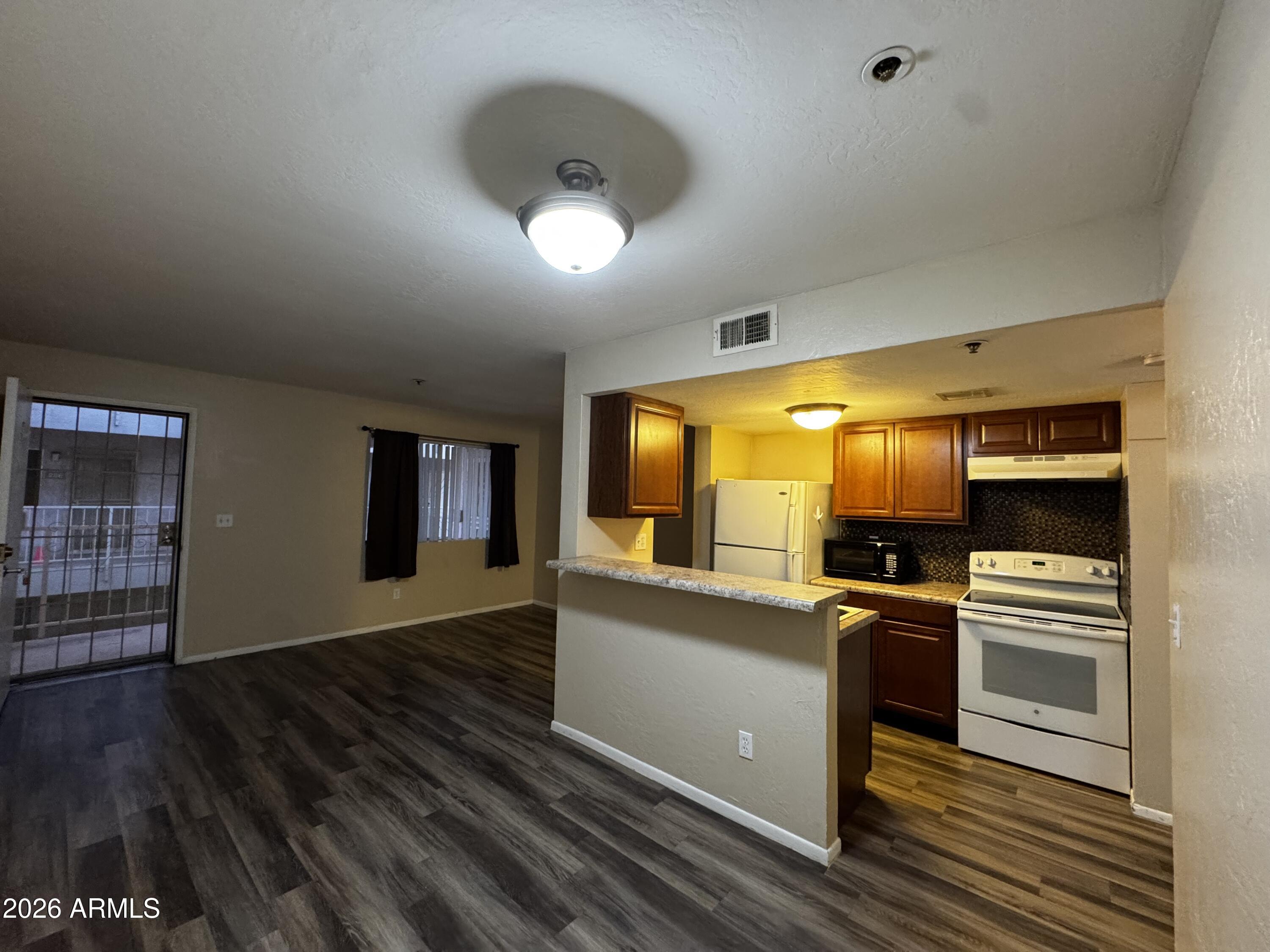 12123 West Bell Road, Unit 258 Surprise, AZ 85378 - Photo 3 of 30 workspace with wooden floor electronic appliances and windows